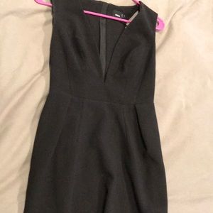 Mini low cut black dress.